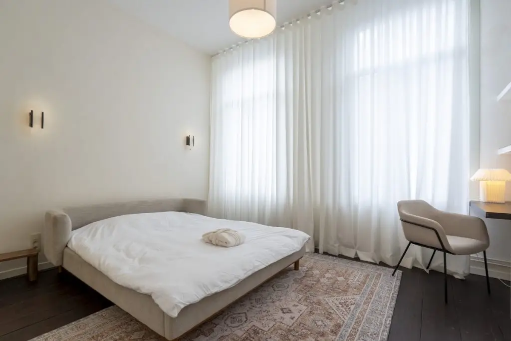 Shared Luxury in Antwerp: Opulent bedroom retreat, capturing the spirit of communal elegance